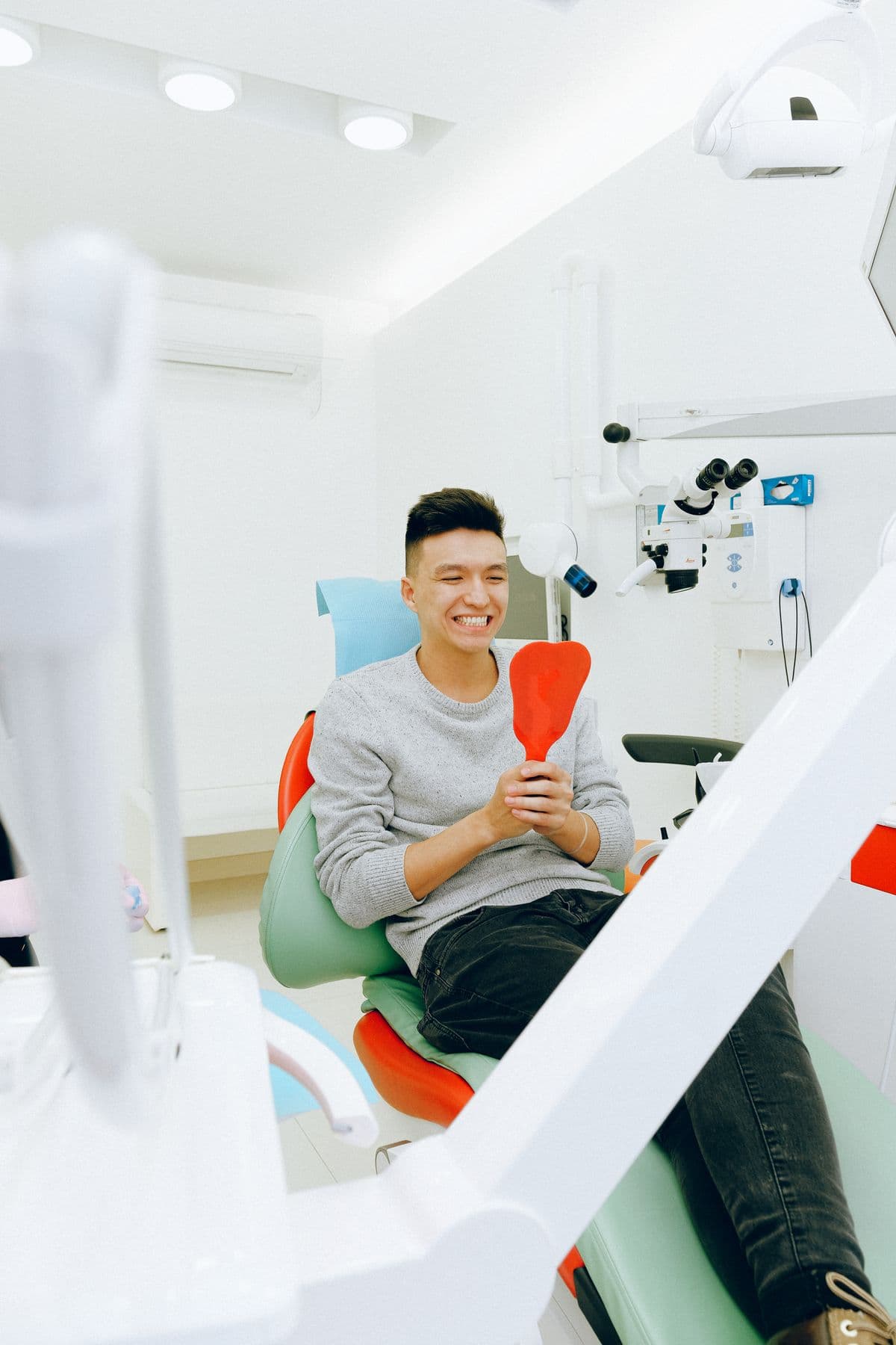 Young man smiling in a dental chair